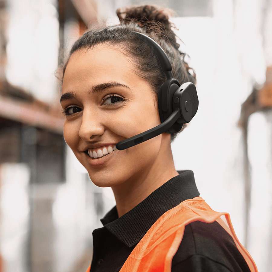 Female warehouse worker wearing Jabra Perform 75 headset